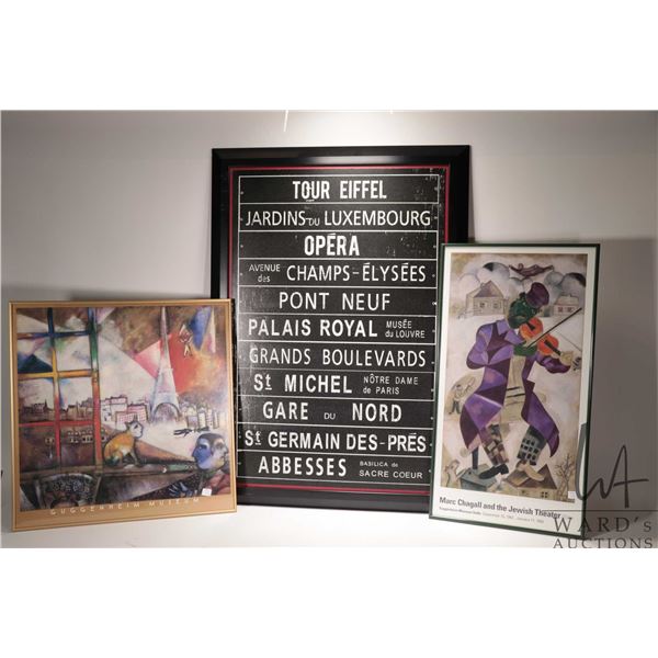 Three framed art works including two Marc Chagall Museum posters and a Paris street menu. Note: Not 