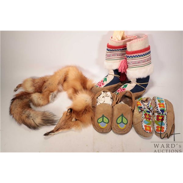 Two pair of beaded moccasins, needle work and fur mukluks and fox fur stole. Note: canadian bidders 