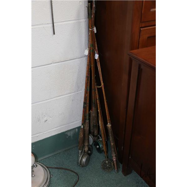 A selection of seven antique split cane fishing rod, four of them fitted with reels