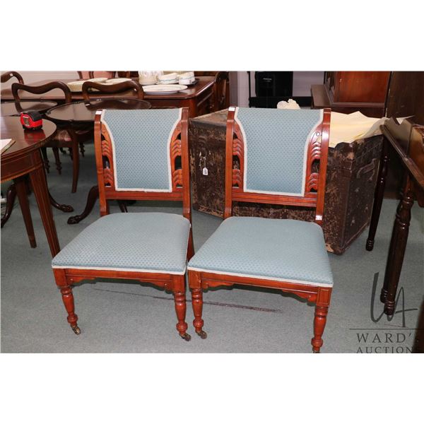 Pair of matching antique slipper chairs with turned supports, sitting on brass castors, each with bl