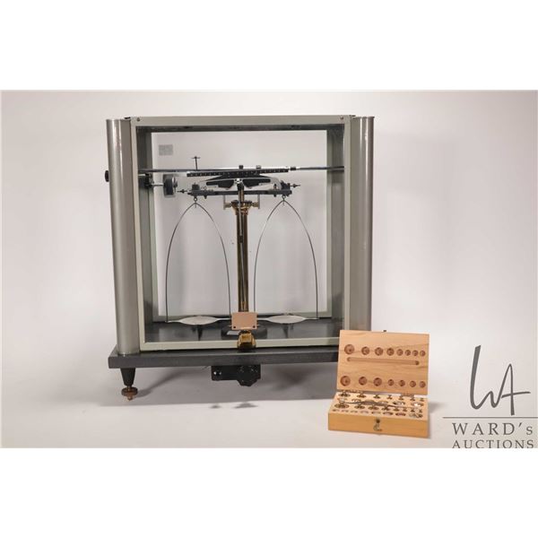 Scientific scale in glass and metal case and includes fitted set of weights. Note: Not available for