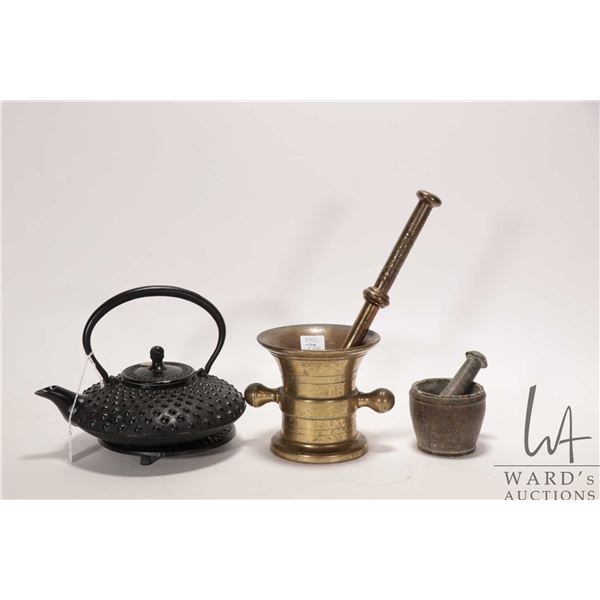 Two mortar and pestle sets including one stone and one brass plus a cast iron Oriental teapot with s