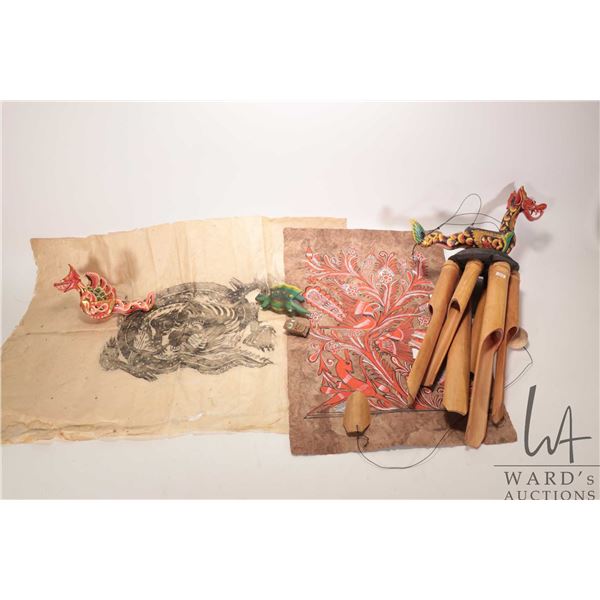 Selection of Indonesian collectibles including painted dragon mobile and chimes plus a carved reptil