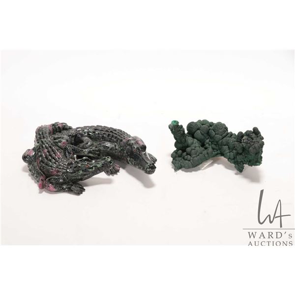 Piece of natural botryoidal malachite and a hand carved gemstone crystal in the shape of two crocodi