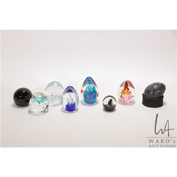 Seven art glass paperweights including at least one signed plus a soapstone egg