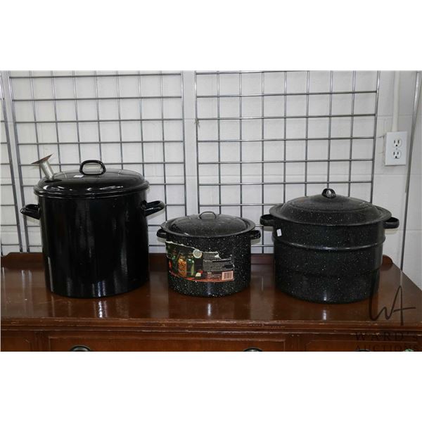 Seleciton of enamel canning cookware including two with jar galleys and one with funnel top 14" in h