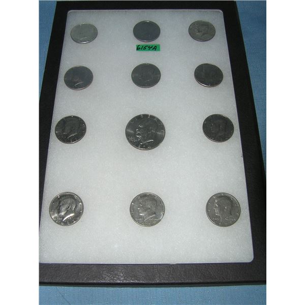 Kennedy half dollar coins and an Eisenhower dollar