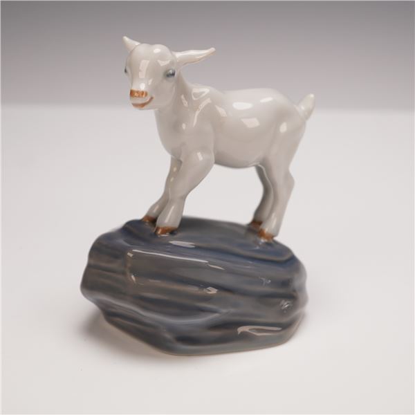 Royal Copenhagen Kid Figurine on Rock