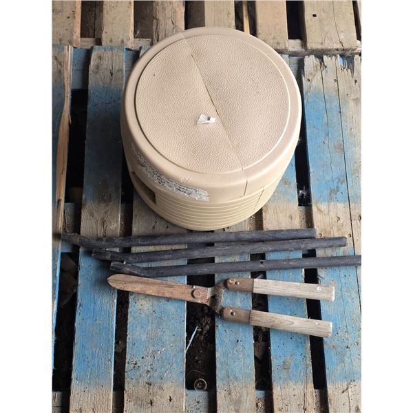 Porta potty, metal pipes and garden shears