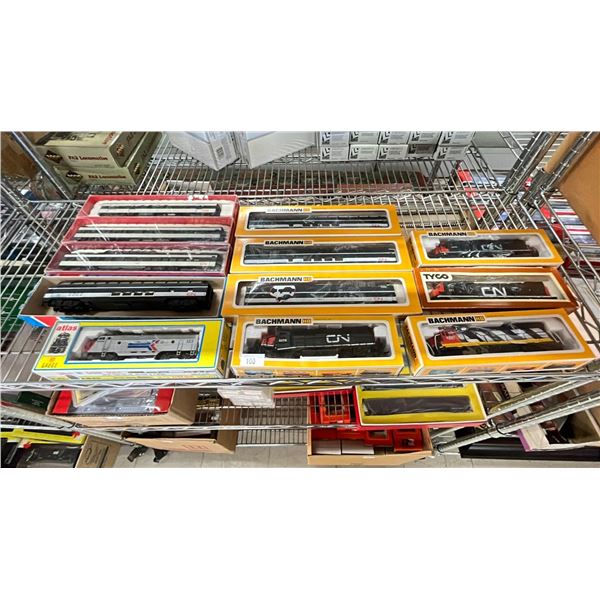 SHELF OF ASSORTED SCALE MODEL TRAINS