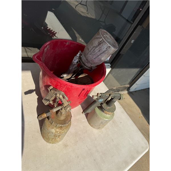 Paint, sprayers and bucket