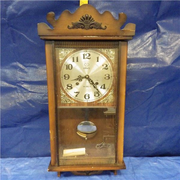 Glory 31 day pendulum clock with key  Some damage to top right hand corner