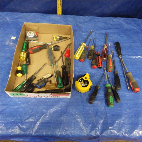 assortment of screwdrivers and tape measures