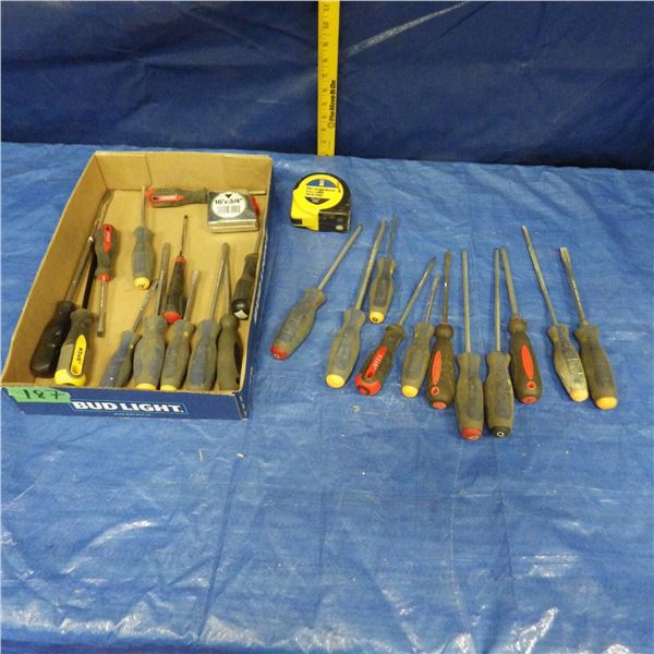 assortment of screwdrivers and tape measures