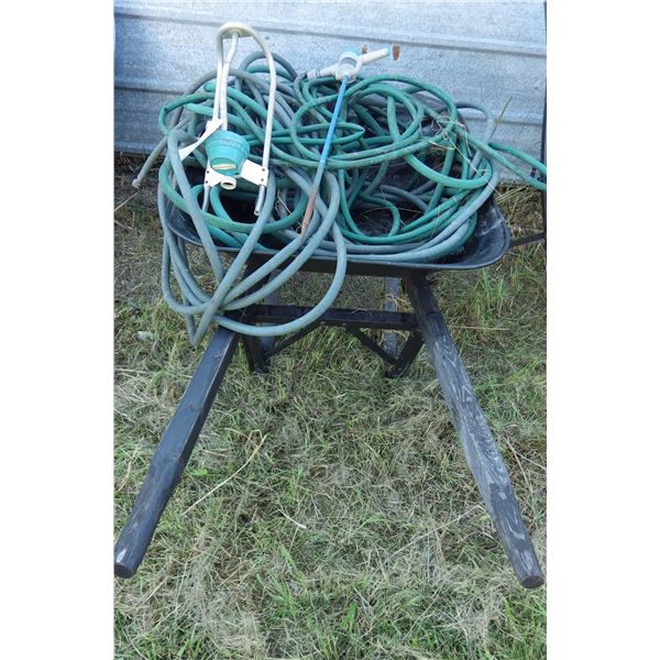 wheelbarrow with garden hose and water sprinkler