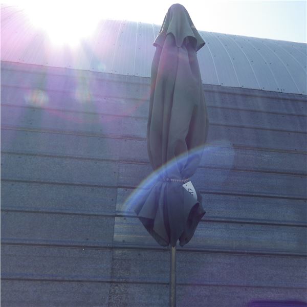 Patio umbrella with cast stand and small end tables