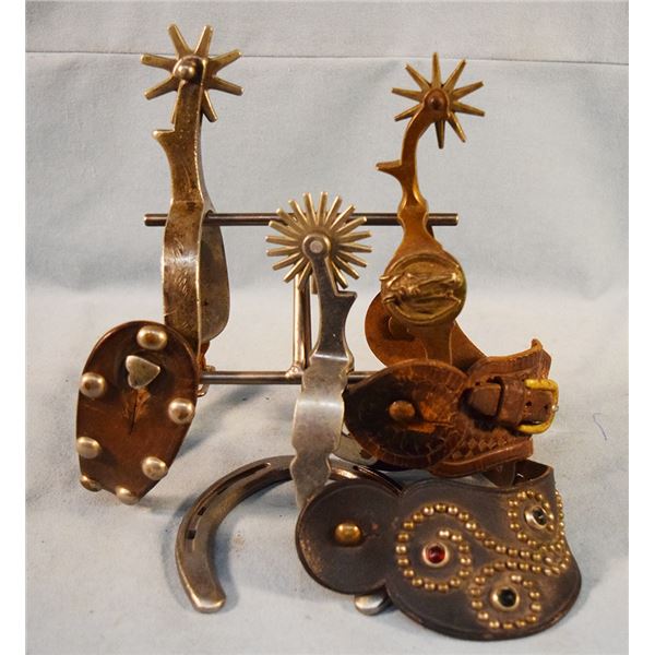 (3) Buermann single spurs with straps - one Hercules bronze horsehead; one star steel silver big spu