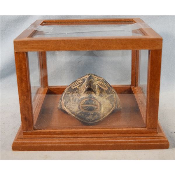 Incan decorative face mask in glass case