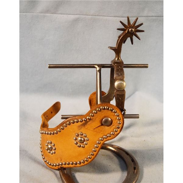 North & Judd single spur with fance studded strap, spur has etching on the nickel silver spot