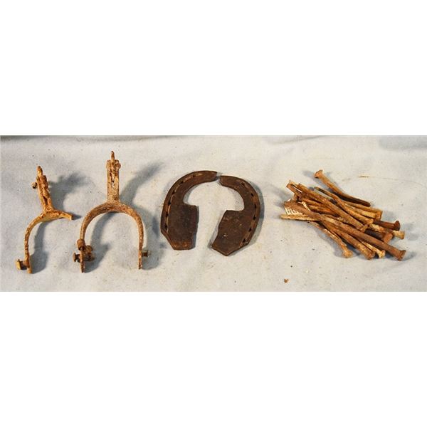 Assortment of primitive iron pieces - ox shoe, square nails, spurs