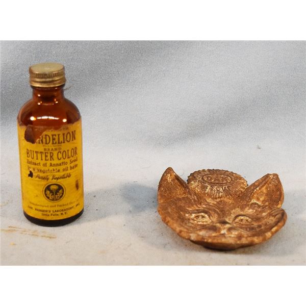 2 pcs: Bottle of Dandelion butter coloring, partially full & cast iron cat head spoon rest