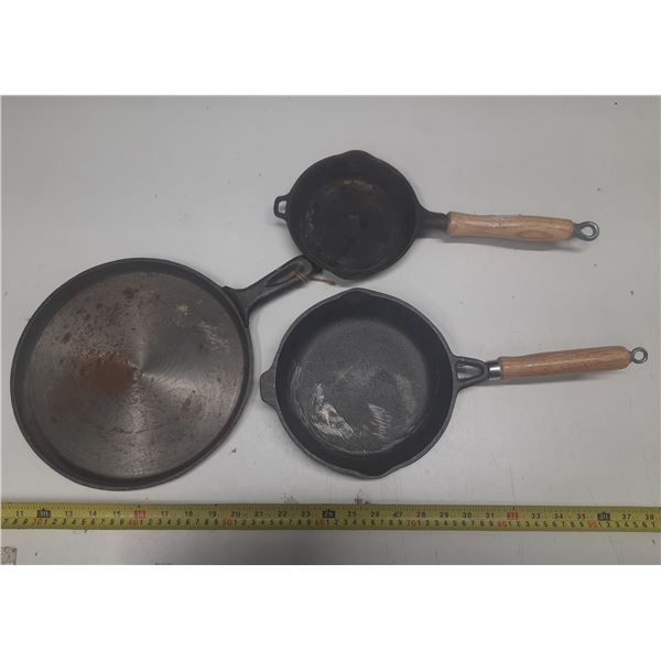 (3) Cast Iron Pans. (Two are with wooden handles)