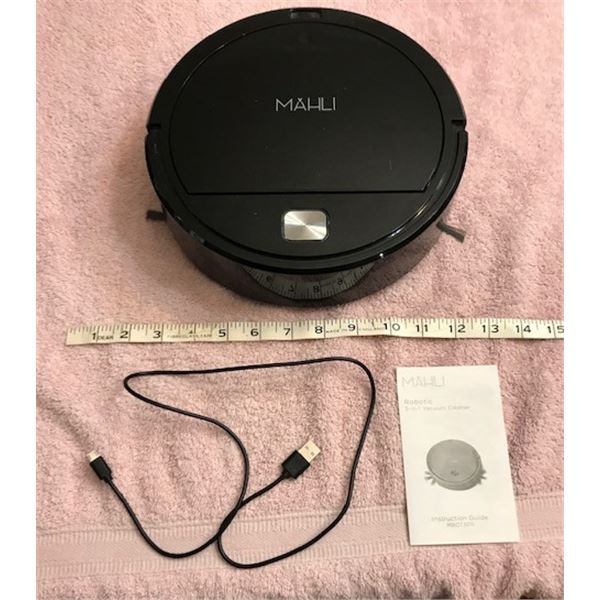 #556: MAHLI Robotic Vacuum Cleaner with charger and instruction guide. Works. Use only on a non-carp
