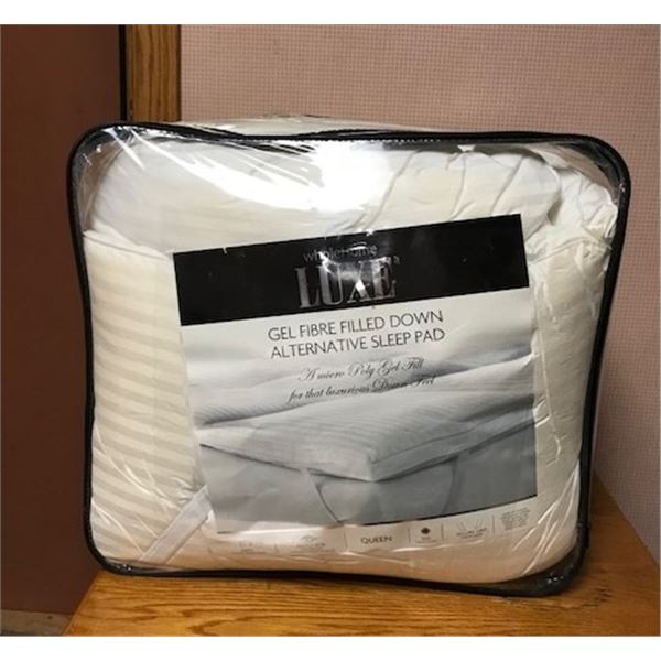 #558: Thick Queen bed pad for sleeping on a soft surface. Never used. Never unpackaged. Zippered con