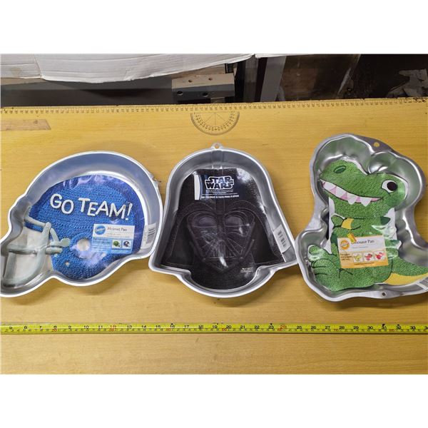 3 cake pans- dinosaur, darth vader, go team
