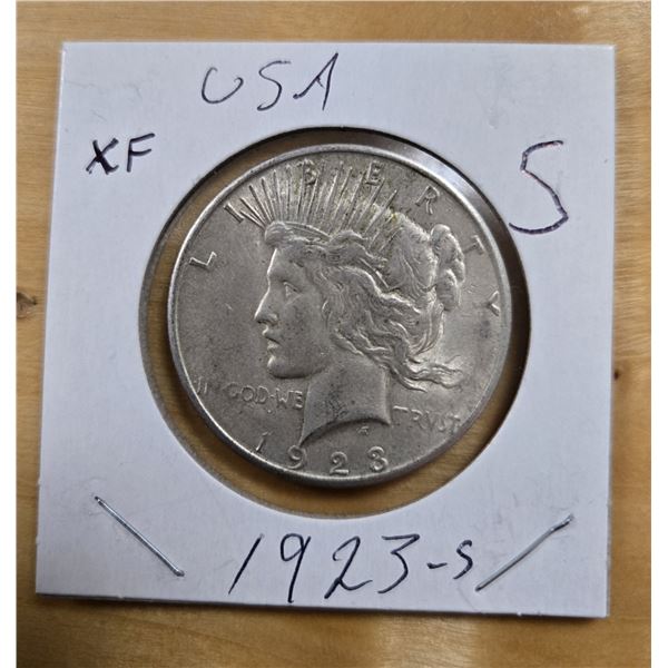 One 1923 American Silver Peace Dollar.
