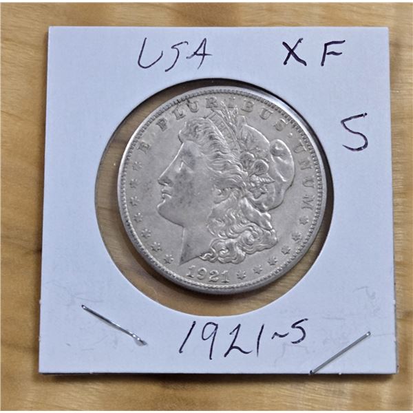 One 1921 American Silver Morgan Dollar.