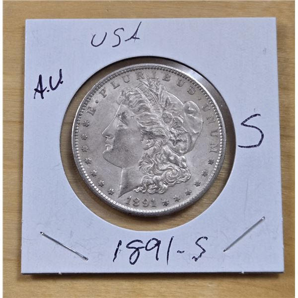 One 1891 American Silver Morgan Dollar.