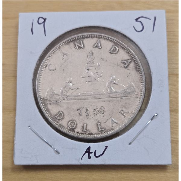 One 1954 Canadian Silver Dollar.