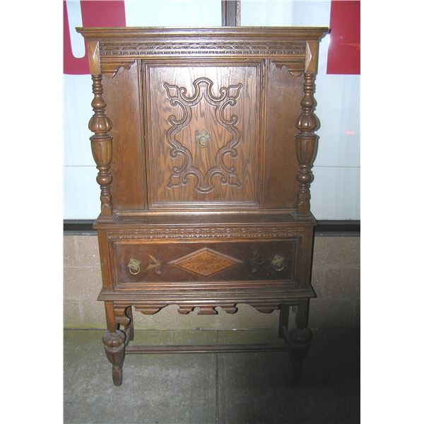 Antique walnut curio cabinet heavily carved