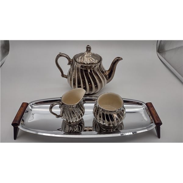 teapot, creamer, sugar bowls, and metal tray.