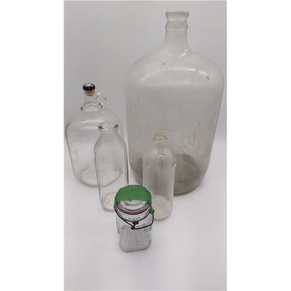 Collection of vintage glass jugs and bottles.