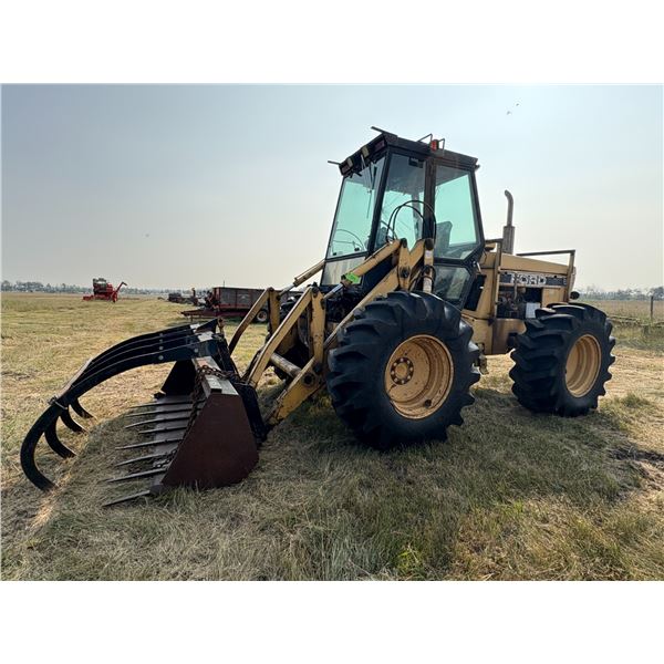 Ford Bidirectional tractor c/w loader & grapple, running order, 18.4x26 tires, showing 7019 hrs, SN.