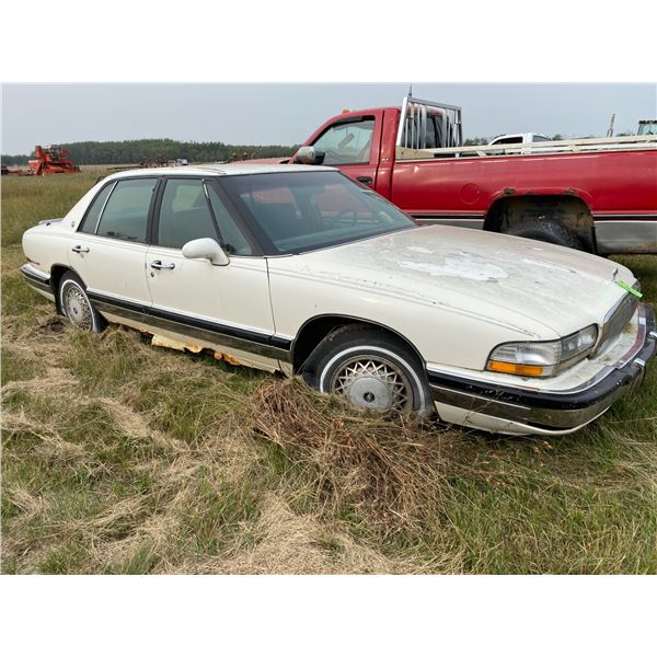 White Buick 4 door sold for parts