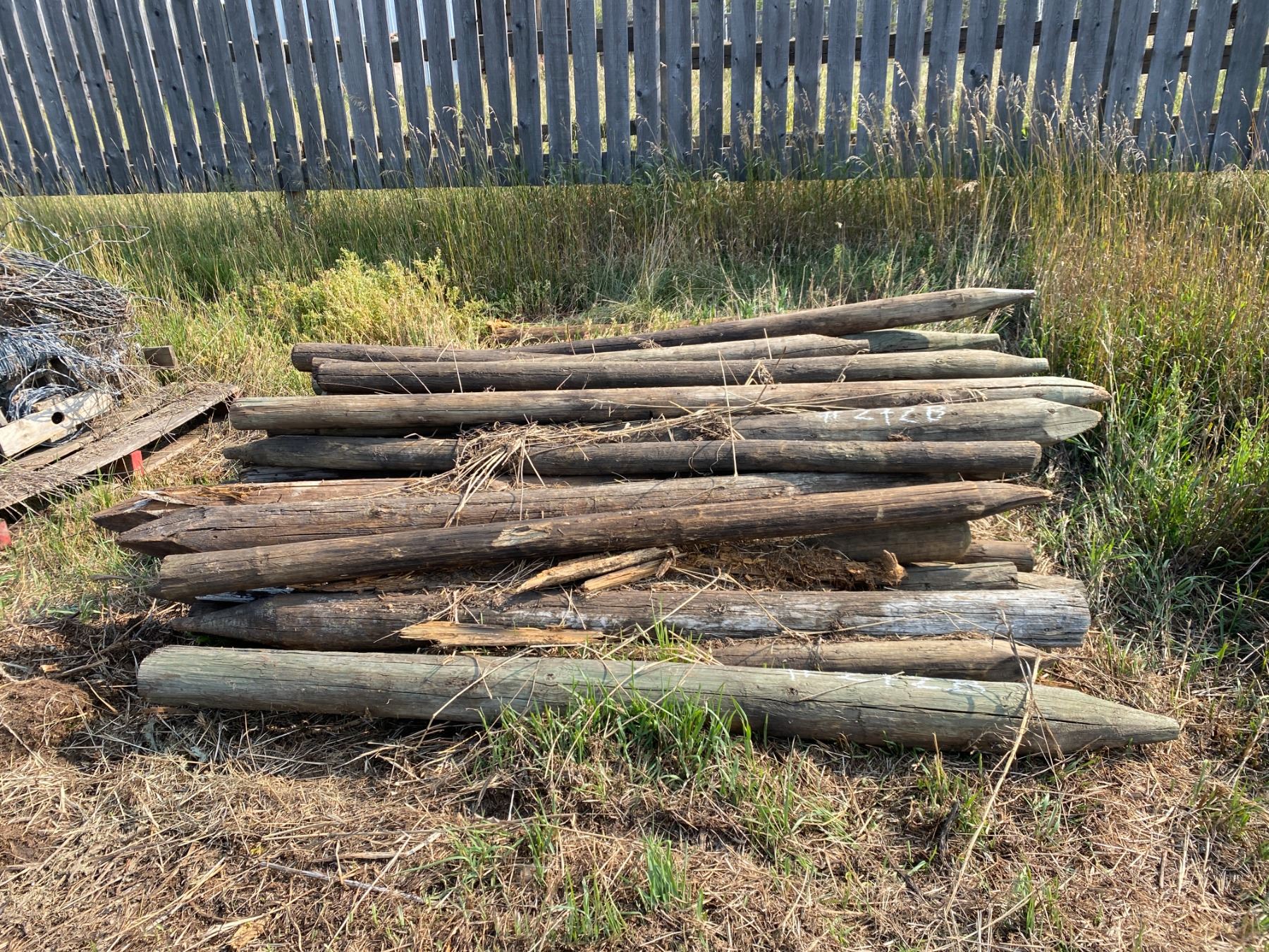 2 piles 0f fence posts selling together