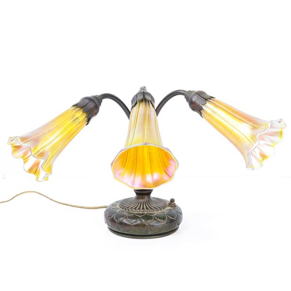 Tiffany Studios New York glass and bronze three light piano table lamp
