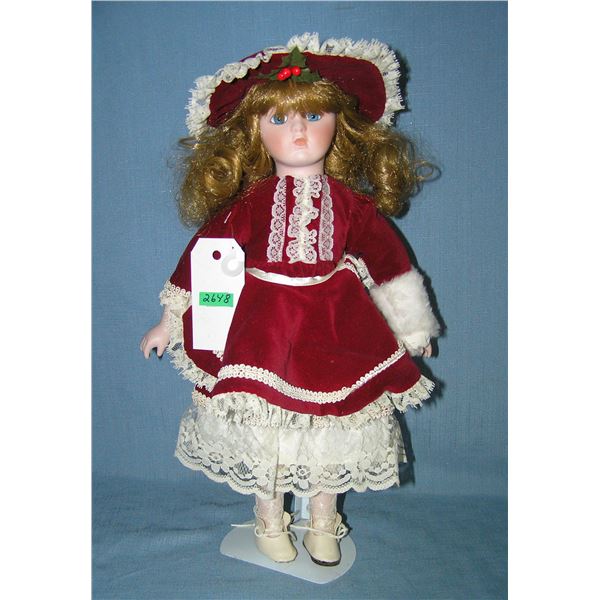 Porcelain doll in fancy maroon dress