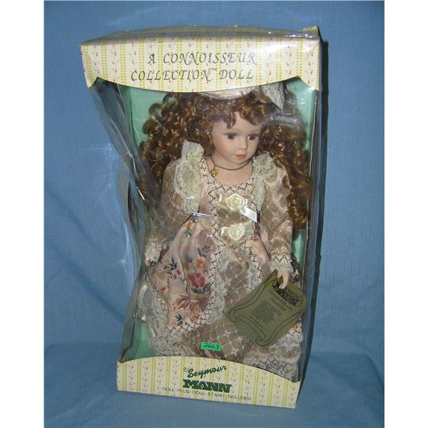 Porcelain doll in fancy dress and hat by Seymour Mann