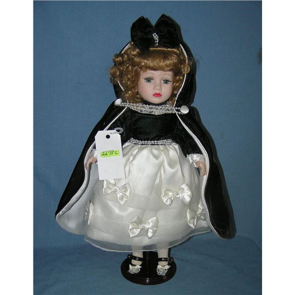 Porcelain windup musical doll in fancy dress