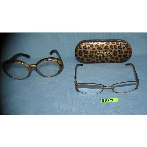 Guess eyeware with a case and a another pair of glasses
