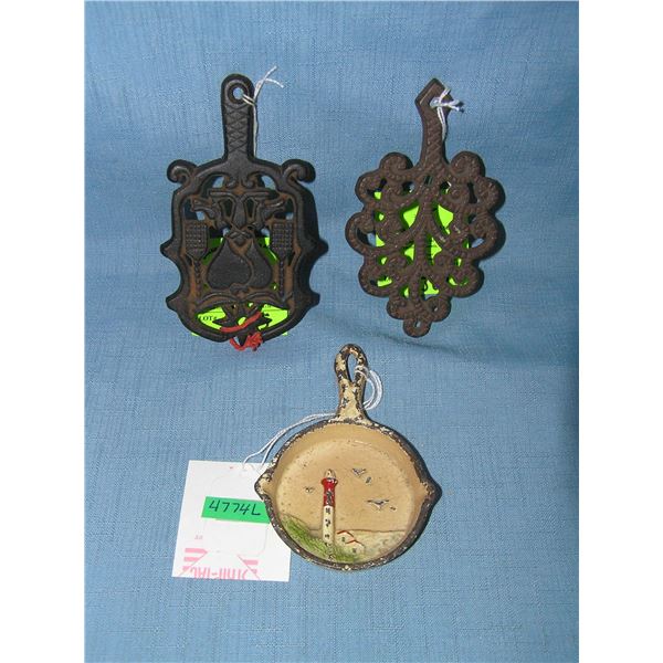 Group of miniture cast iron trivets and frying pan