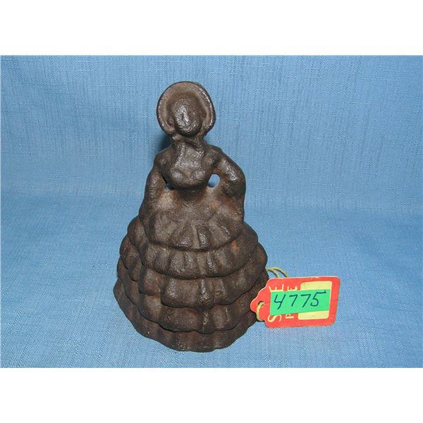 Cast iron woman doorstop with long dress and bonnet