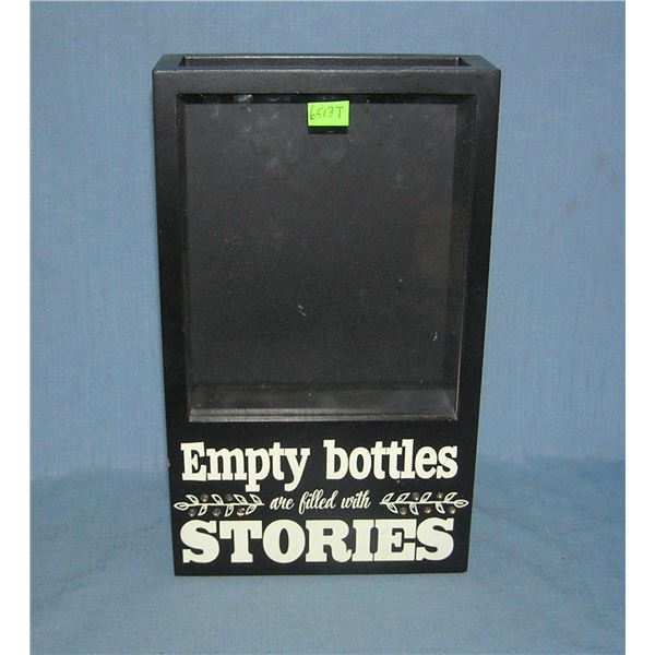 iIlluminated empty bottles are filled with Stories wall mount display
