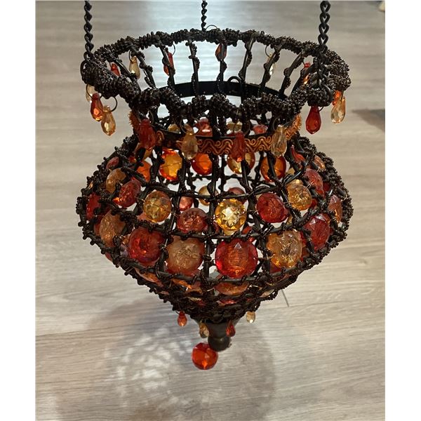boho-style hanging candle holder with amber-colored prism beads