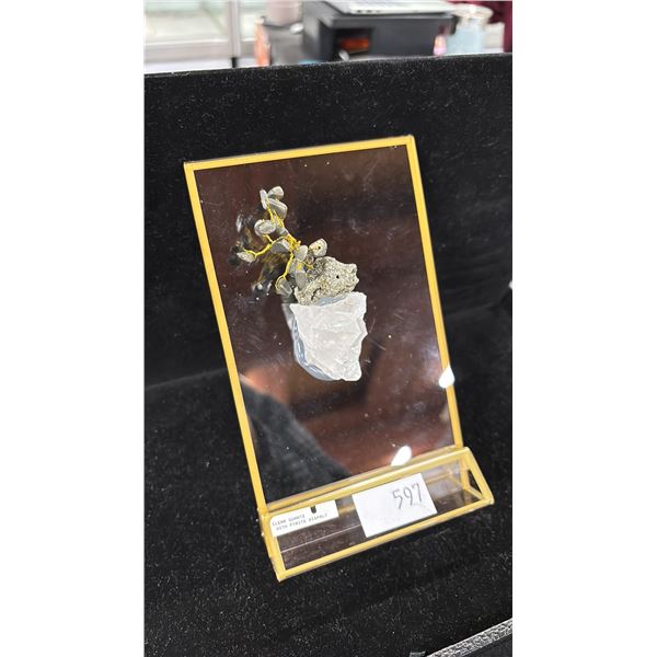 CLEAR QUARTZ WITH PYRITE ON A DISPLAY