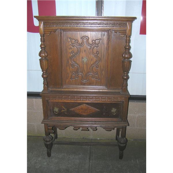 Antique walnut curio cabinet heavily carved